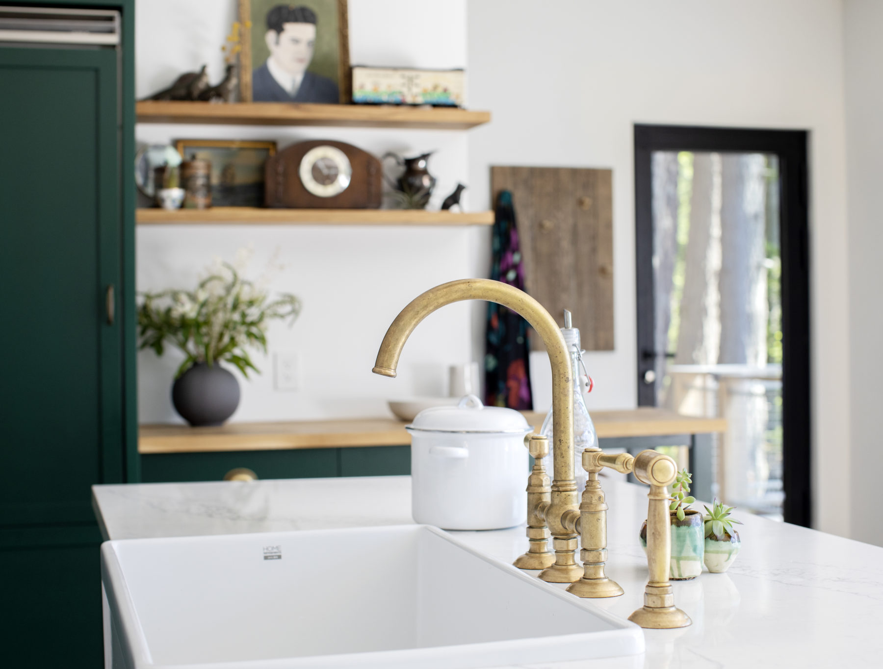 Brass kitchen taps with white sink. Brand new home construction