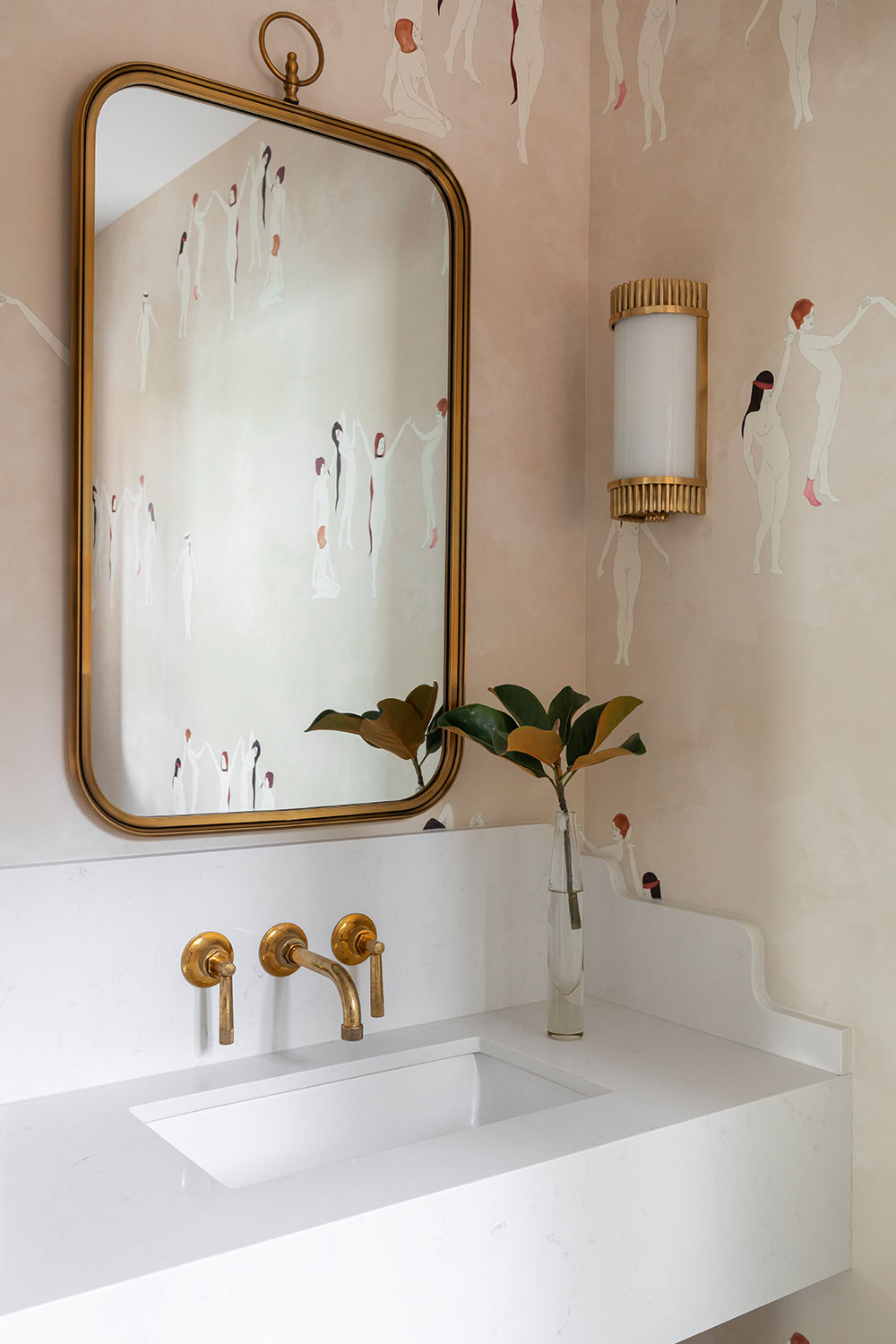 photograph of renovated powder room featuring designer wallpaper, brass fixtures, sink, and lights and modern sink
