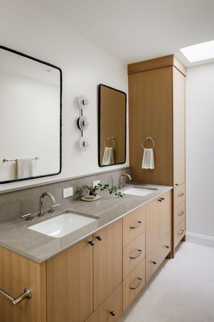 Ensuite double vanity with oak cabinetry and stone counter