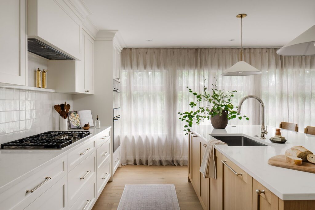 Open kitchen renovation with gas range, custom cabinetry and natural light
