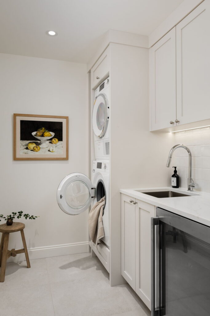 Renovated laundry room with cabinetry, sink and counter space