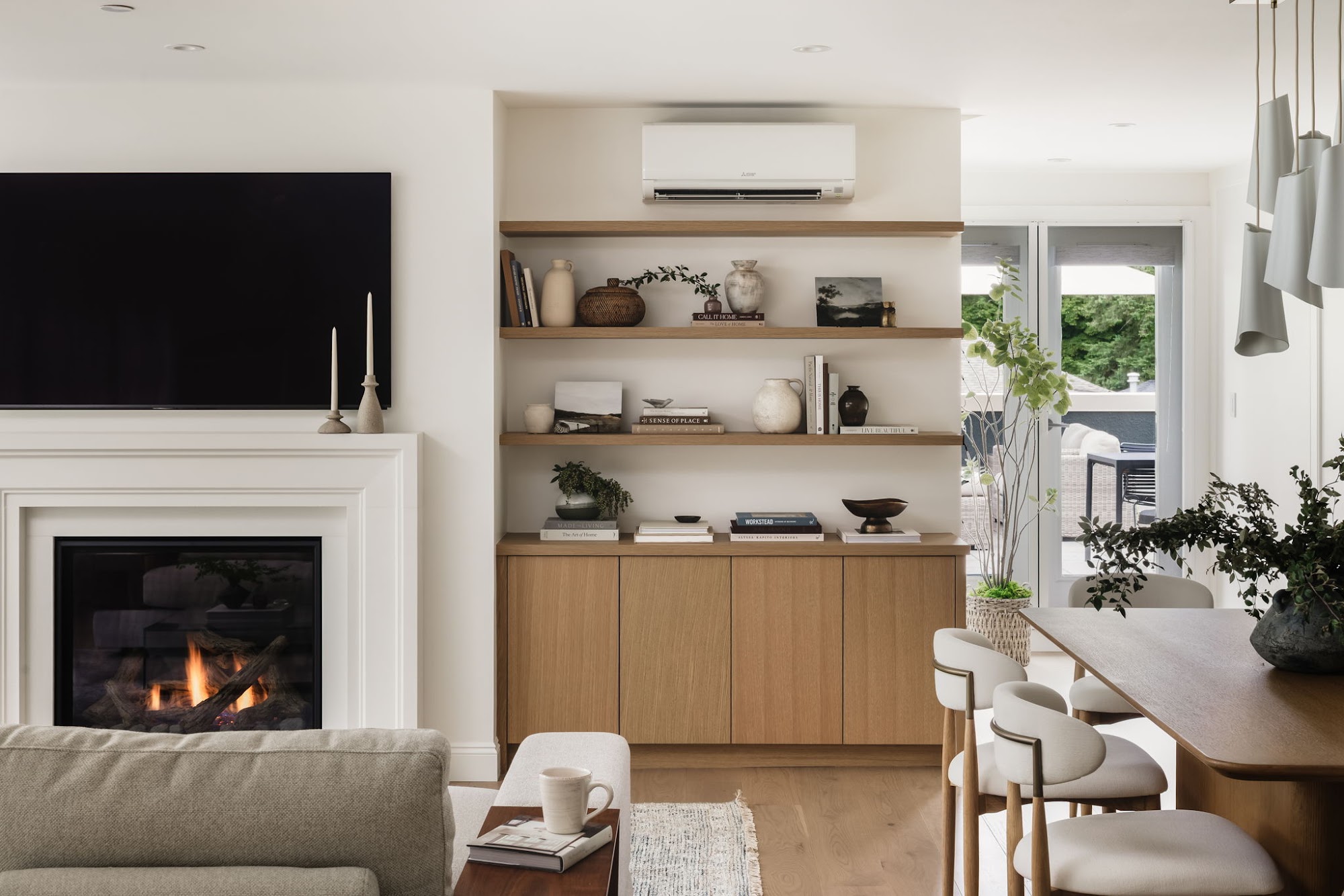 Living room with new fireplace, custom oak millwork and dining area in the Edgemont Blvd condo renovation